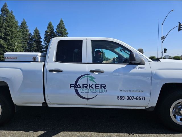 White Parker Enterprises pickup truck with the company logo, license number 1072953 and phone 559-307-6571